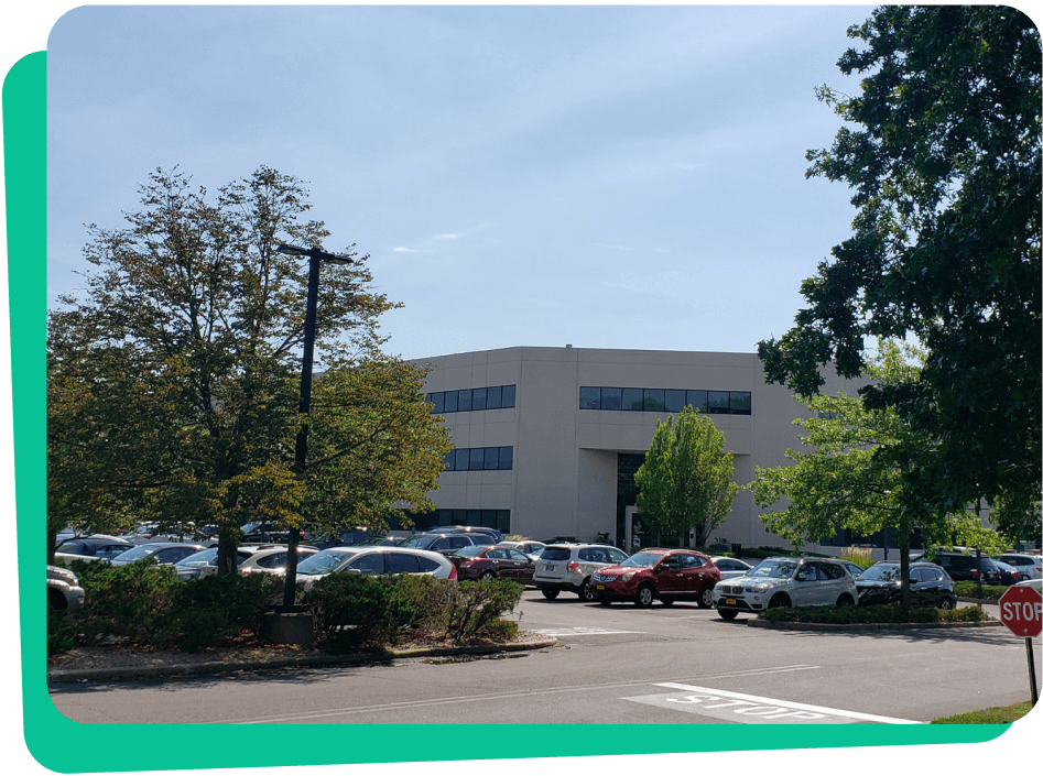 Office park building with parking lot and cars