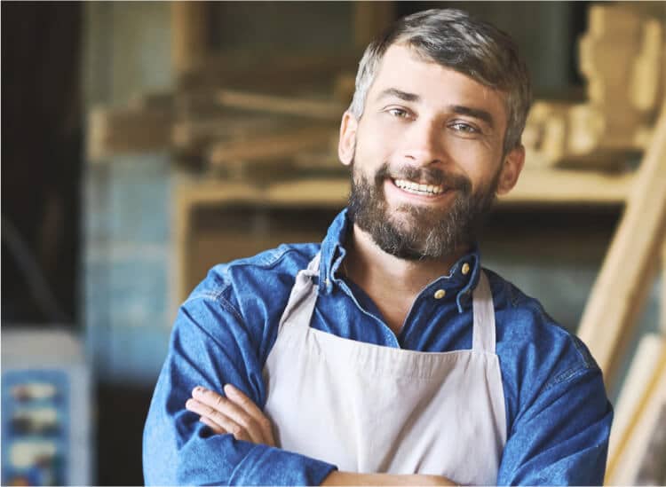 man wearing apron smiling