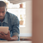 black man looking at tablet screen