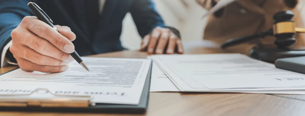 white person's hand writing with pen in notebook