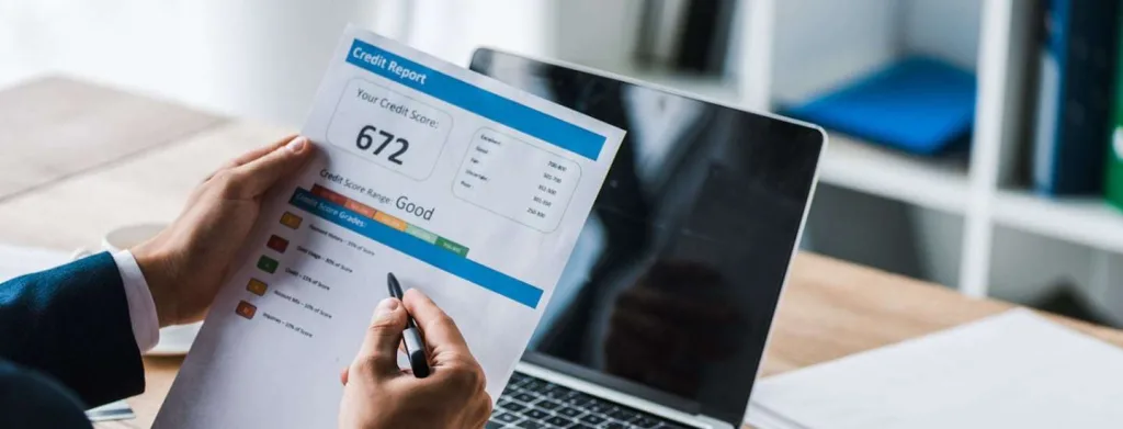a white man's hands holding a paper with charts on it