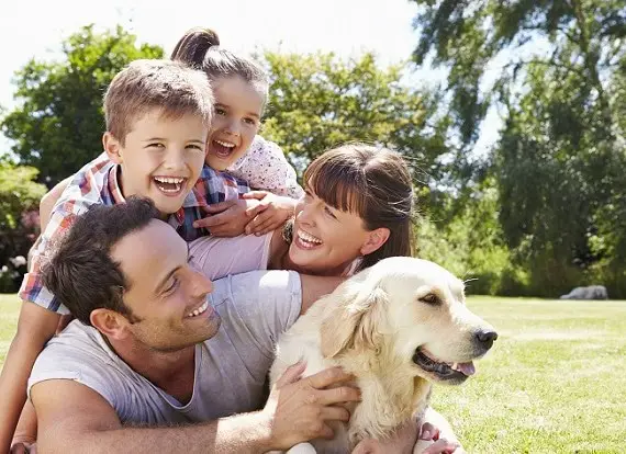 family-relaxing-in-garden-with-pet-dog